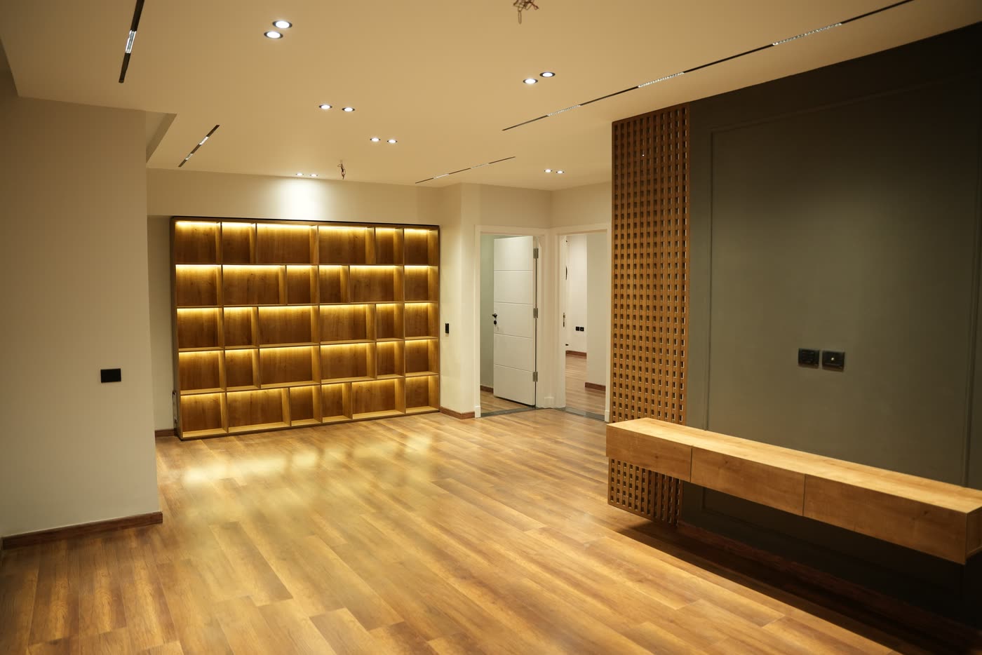 Palm Parks hallway with lit timber shelving and lattice screen
