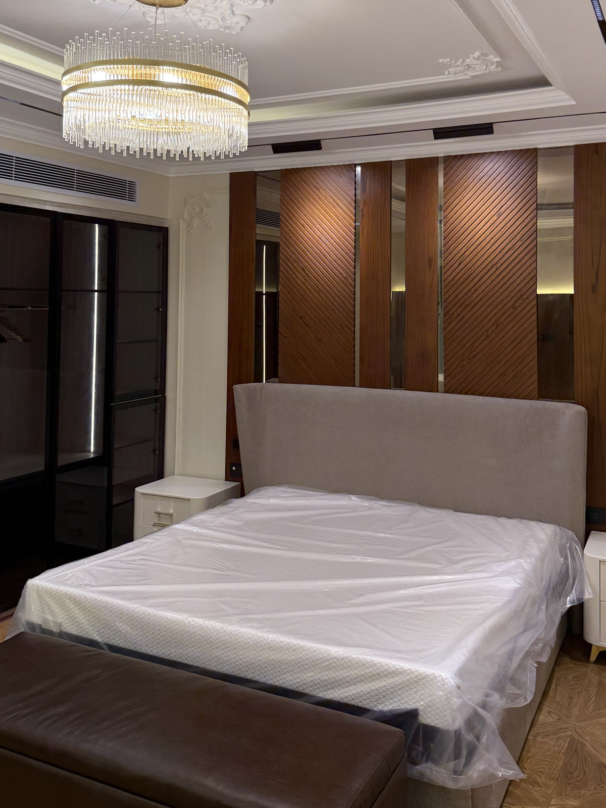 Hyde Park villa master suite with walnut panelled wall